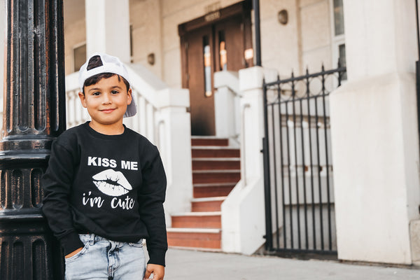 The "KISS ME I'M CUTE" Gossip Kids Unisex Sweater | BLACK